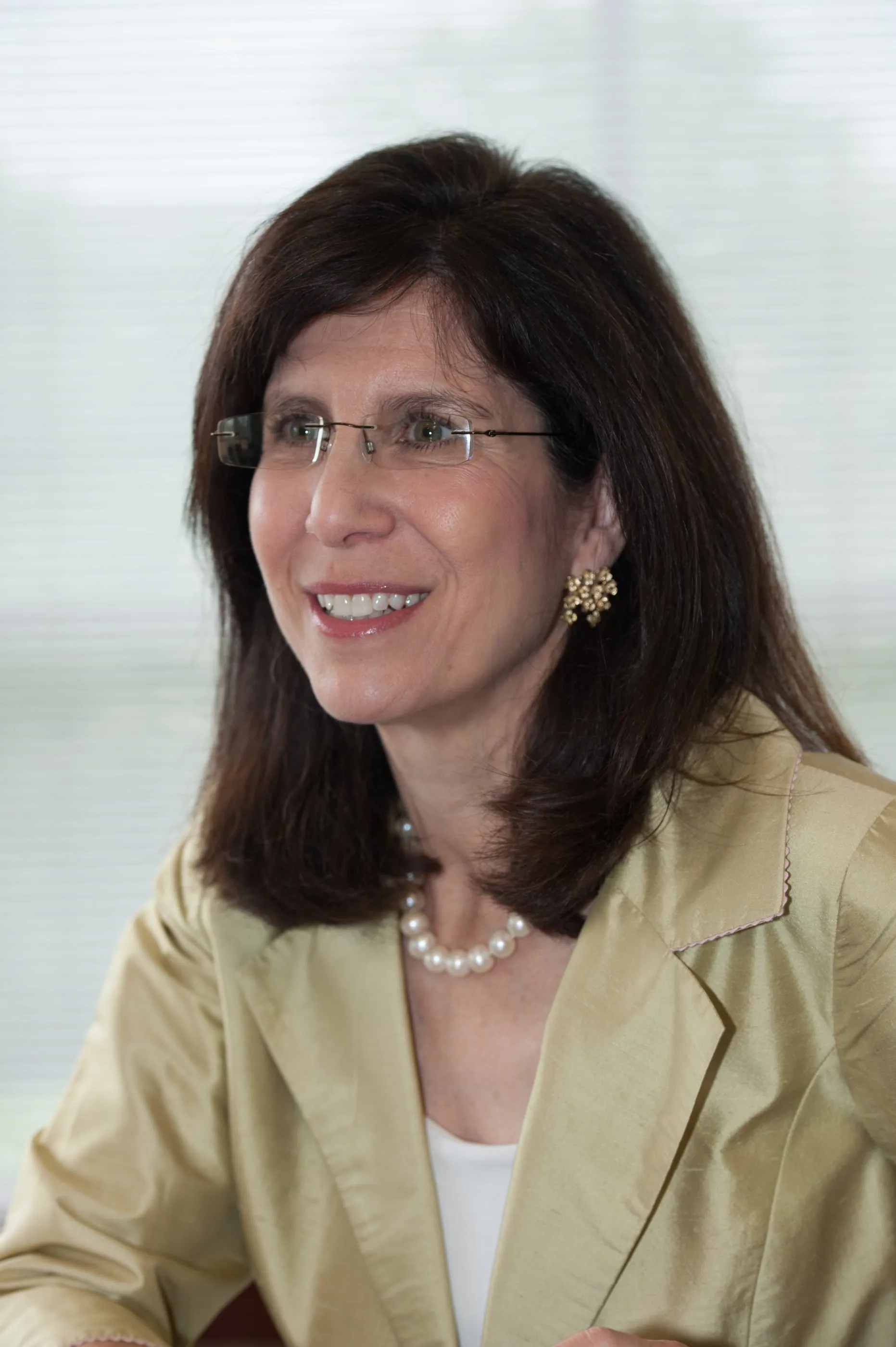Environmental portrait of a woman in a Cambridge biotech building, window light behind her