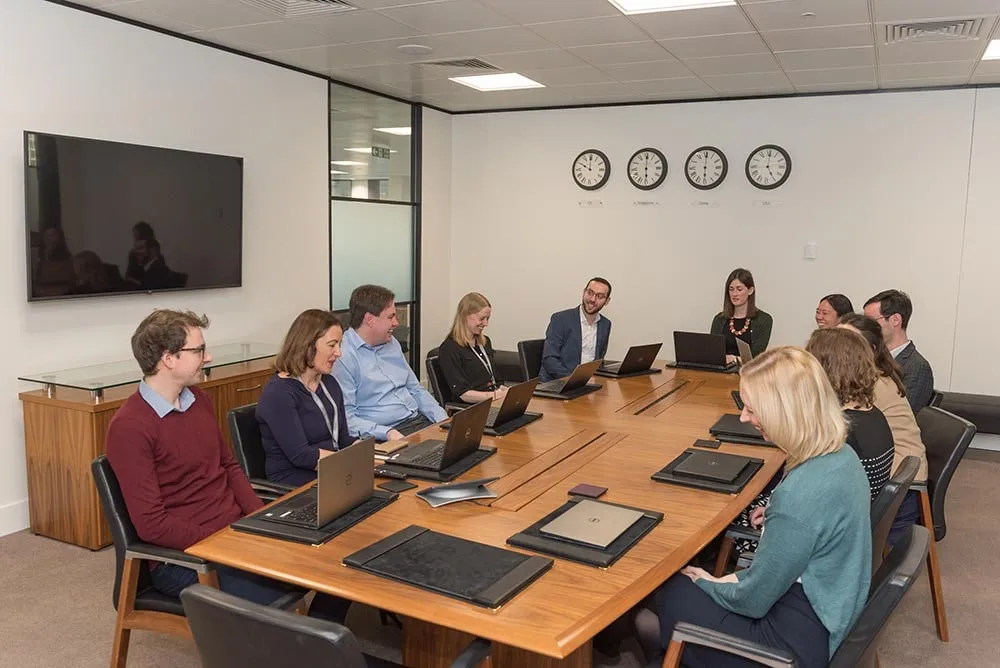 A full boardroom table photographed during a meeting