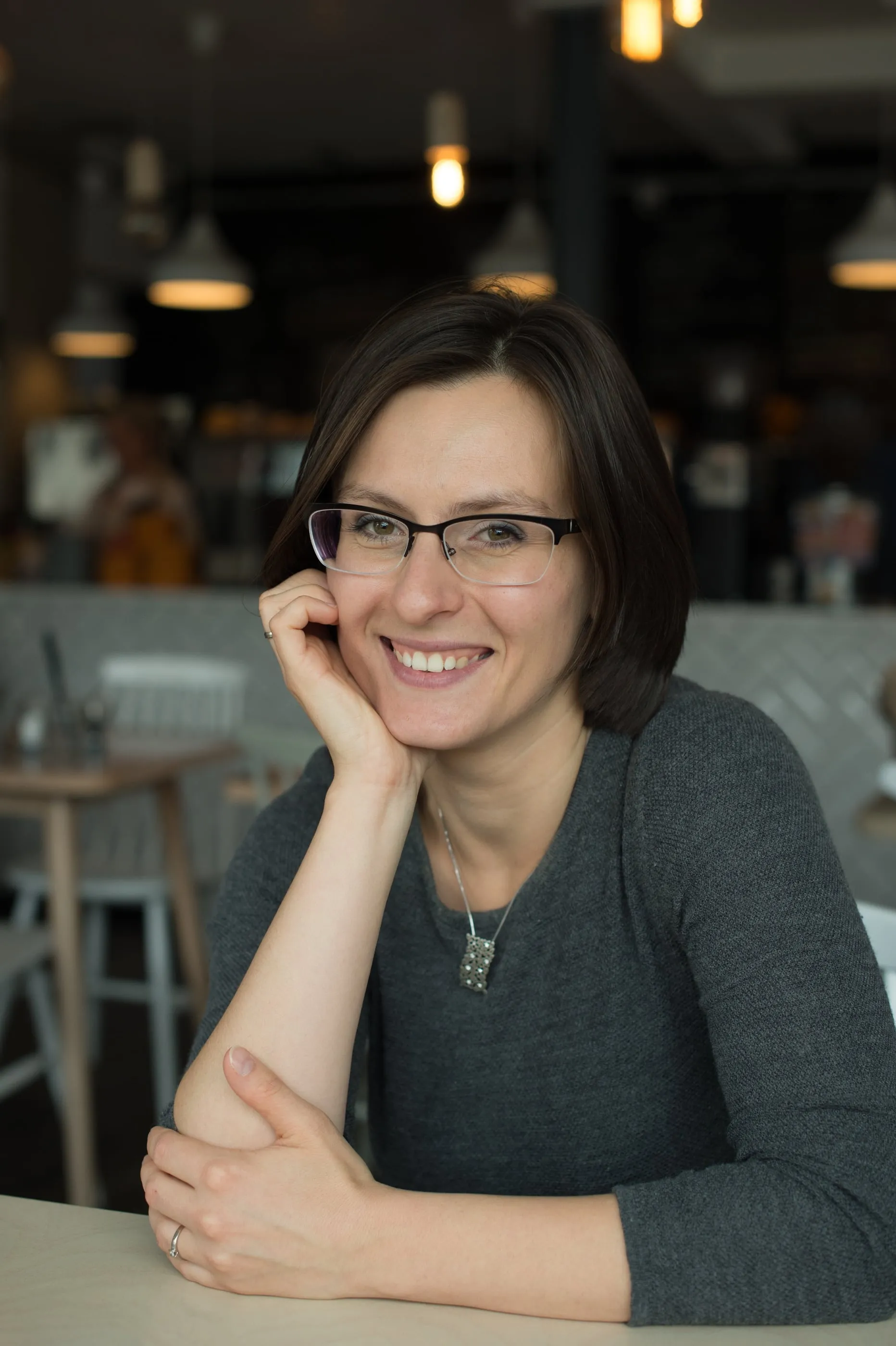 A portrait photographed in a café, natural light from the window