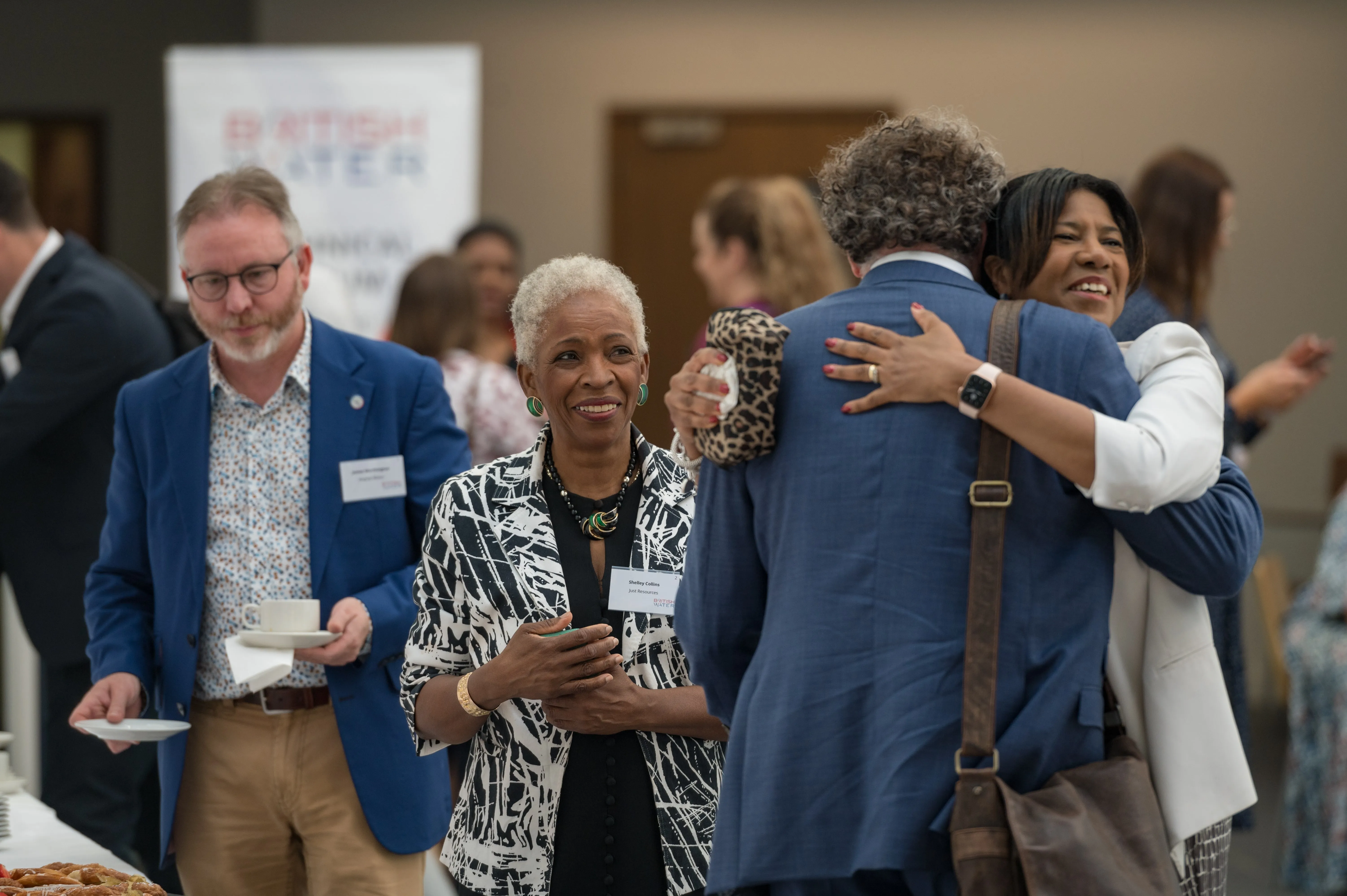 Delegates networking over coffee at a conference