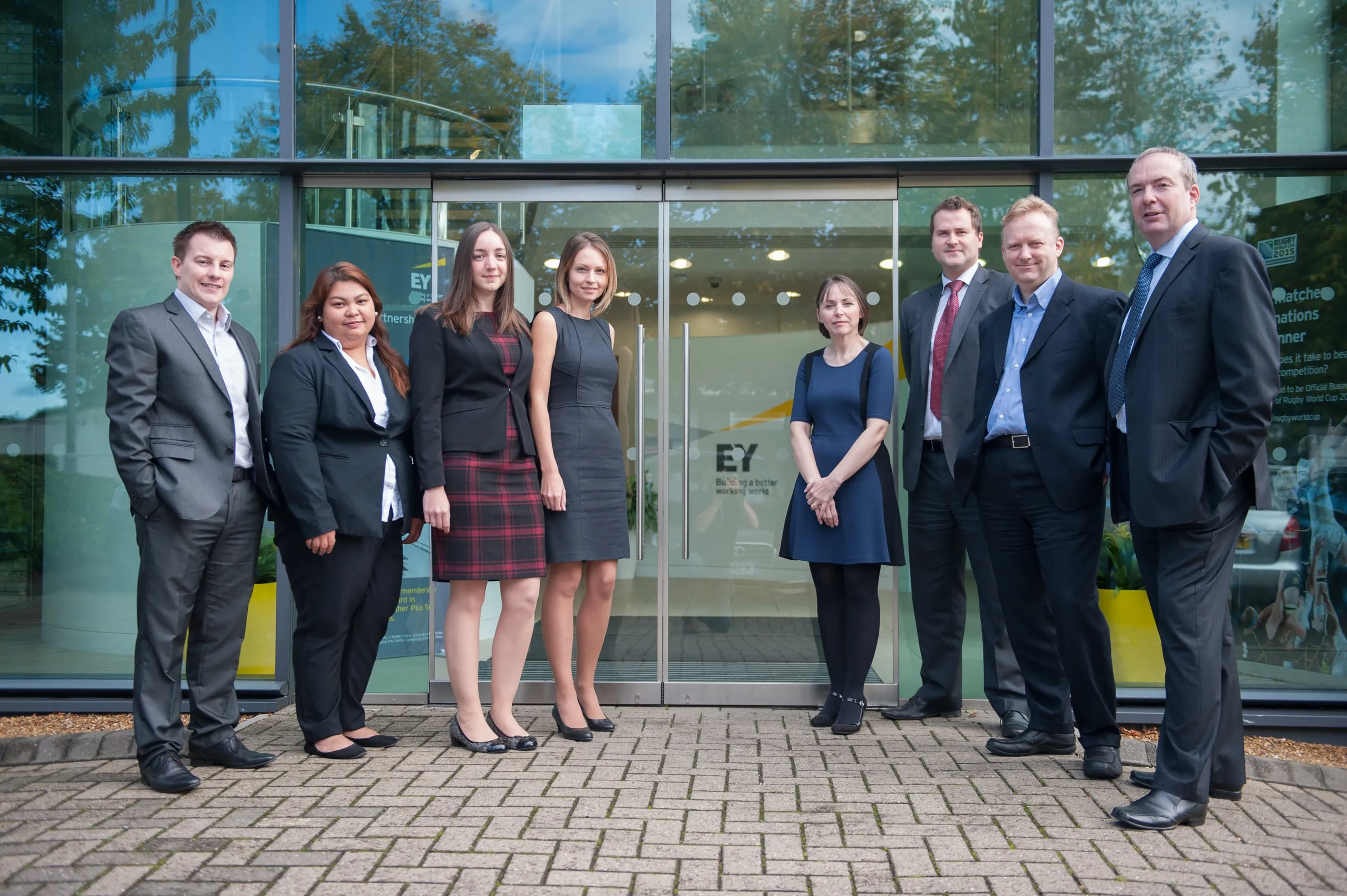 Colleagues talking in an open-plan professional services office in Cambridge