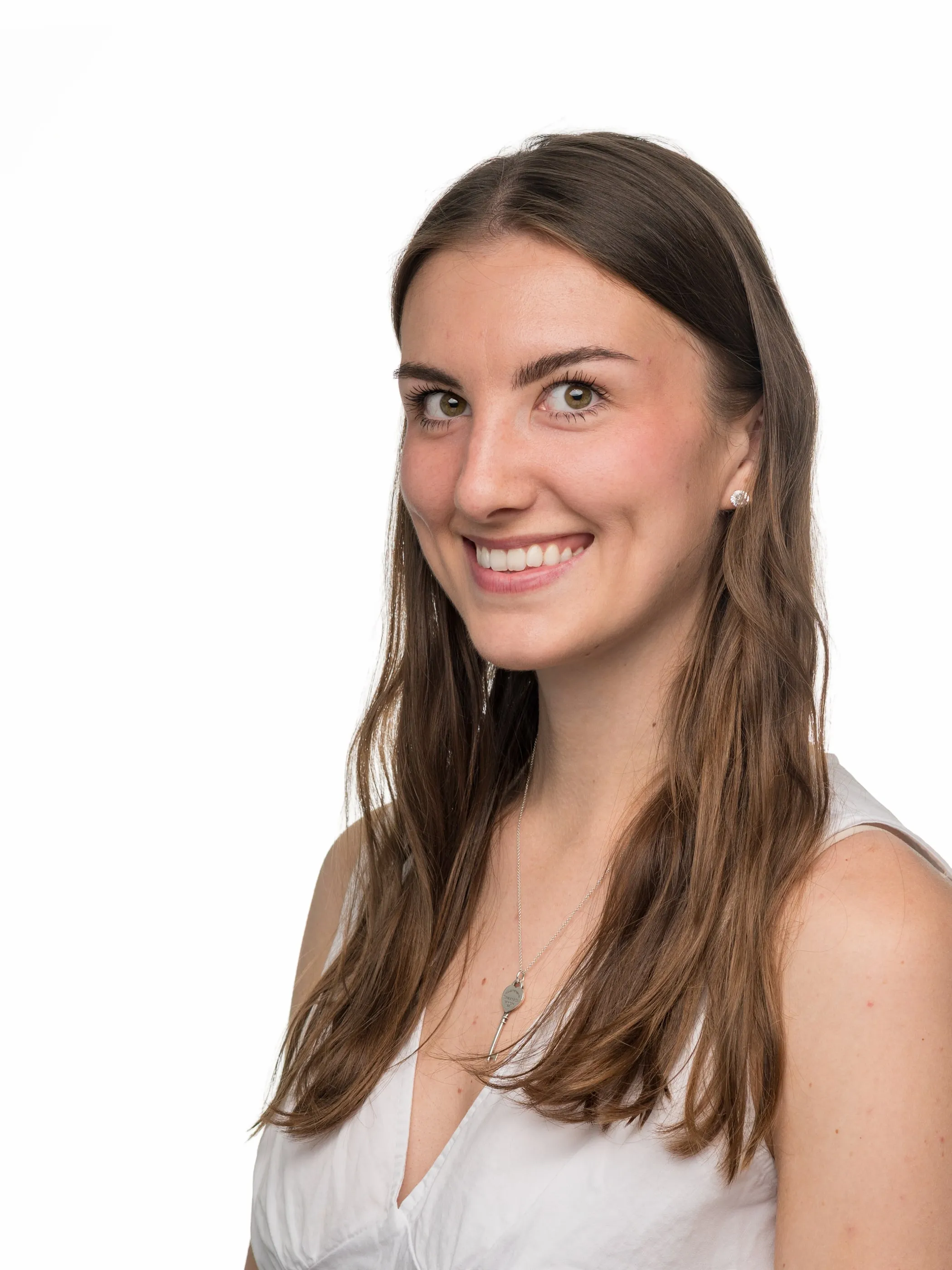 Corporate headshot of a woman in a white top on a white background