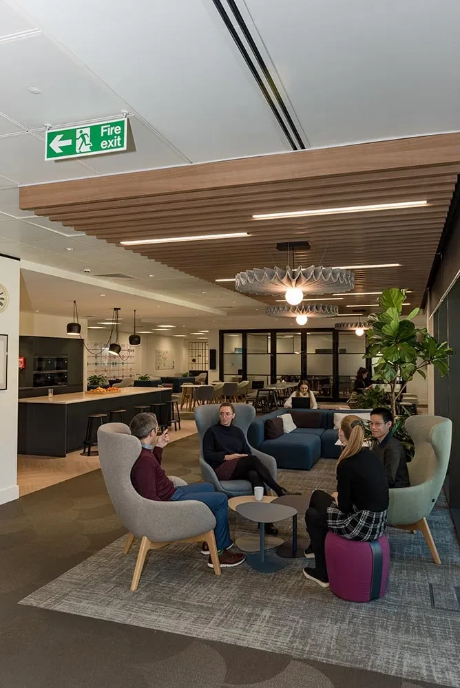 An open-plan office with people working in soft seating
