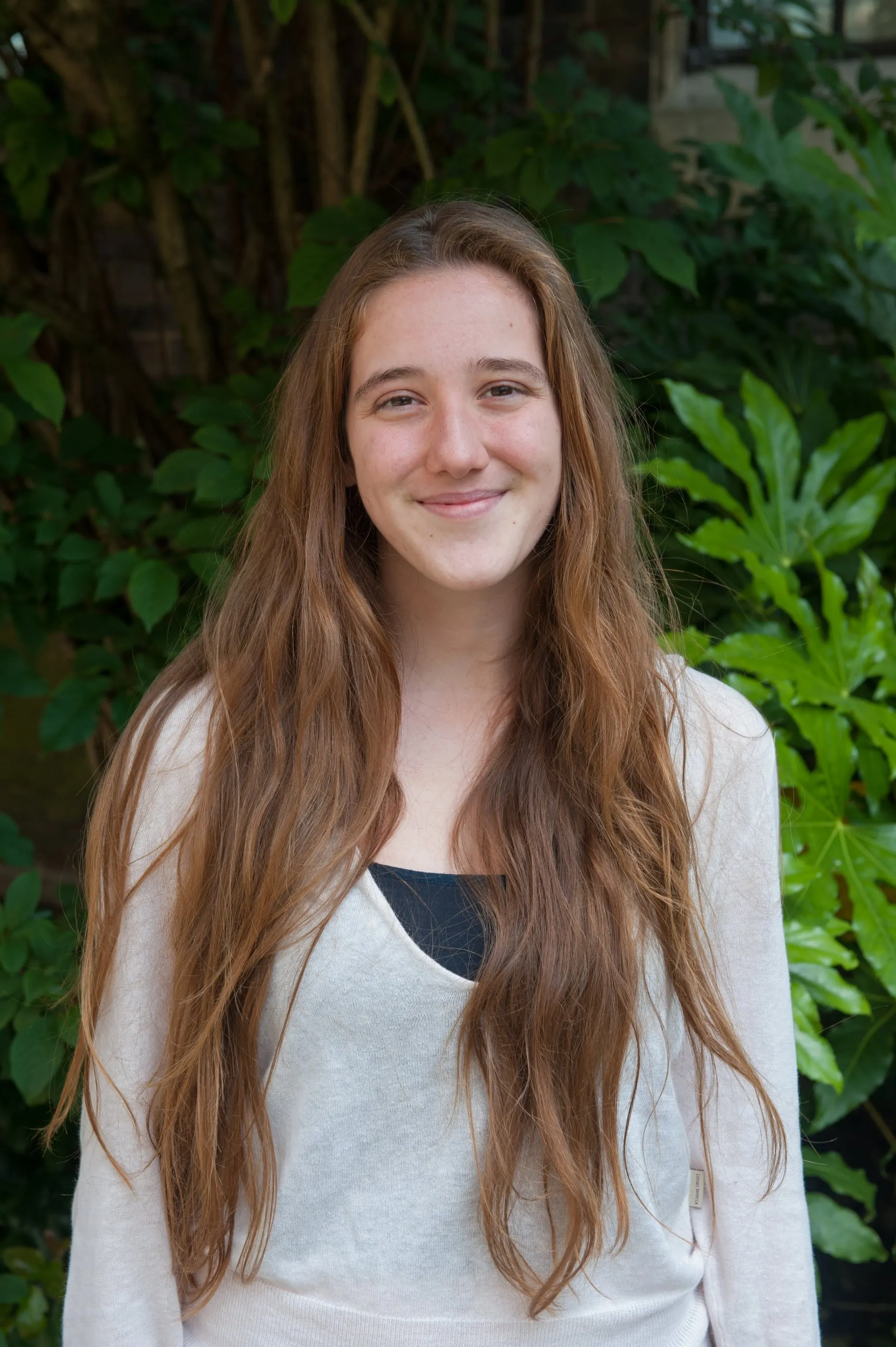 An environmental portrait of a researcher photographed among the plants she studies